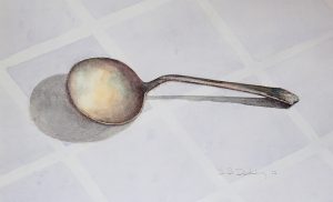 antique spoon on blue napkin